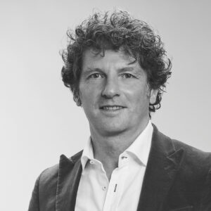 Porträt von Florian Schmittgall in S/W. Er trägt ein Jacket und ein weißes Hemd. Das Bild ist Teil eines Statements über Pharma-Marketing-Trends 2024